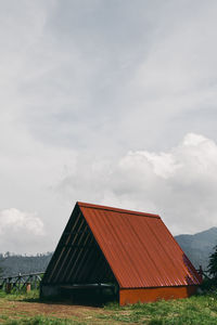 Built structure on field against sky