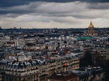 Cityscape against cloudy sky