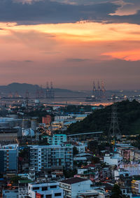 Buildings in city against sky at sunset