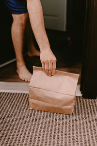 Low section of man standing on floor at home