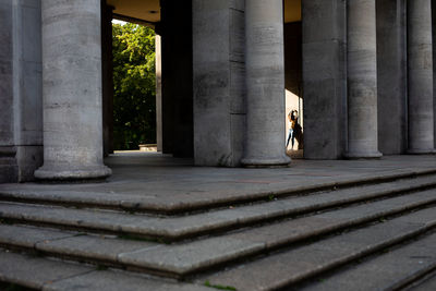 Woman standing at historic building