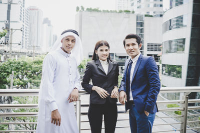 Portrait of business people standing on footbridge