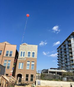 Low angle view of buildings against blue sky