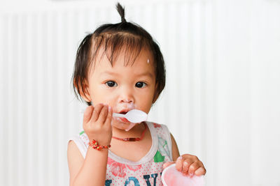 Portrait of cute baby girl eating food