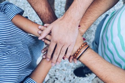 Directly above shot of male friends stacking hands