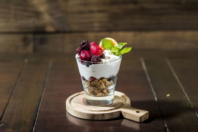 Fresh fruits with ice cream on table