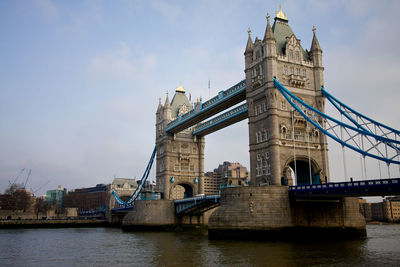 View of bridge over river against cloudy sky