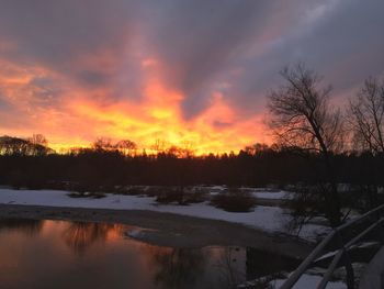 Scenic view of lake against orange sky