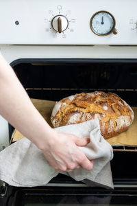 Midsection of person preparing food in kitchen