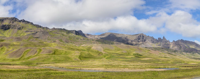 Panoramic view of land and mountains against sky