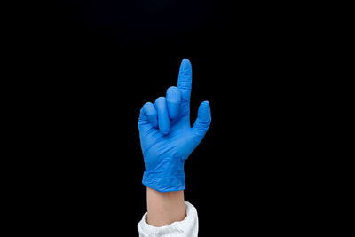 Close-up of human hand against black background