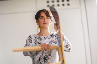 Upcycling young woman on a terrace