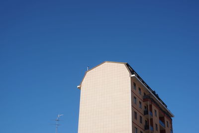 Low angle view of building against clear blue sky