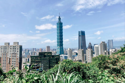 Modern buildings against sky in city