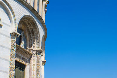 Low angle view of historic building against clear blue sky
