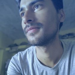 Close-up portrait of young man looking away