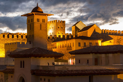 Low angle view of illuminated buildings against sky