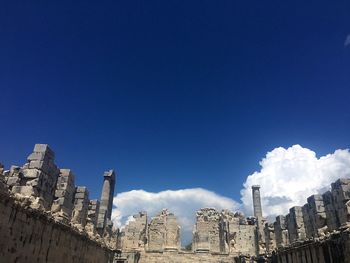 Low angle view of buildings against blue sky