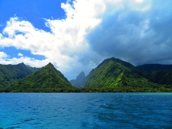 Panoramic view of sea and mountains against sky