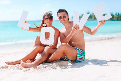 Young couple sitting on beach