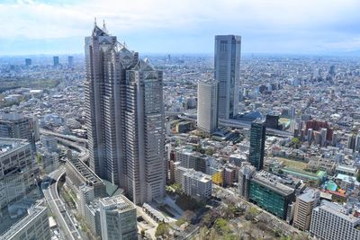 High angle view of modern buildings in city against sky