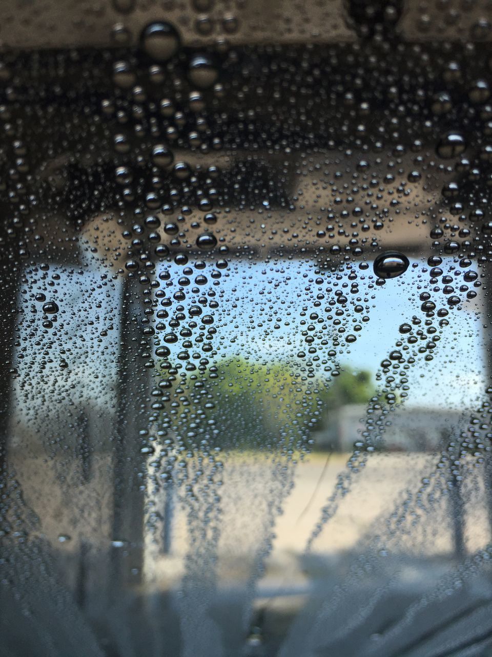 CLOSE-UP OF WATER DROPS ON GLASS WINDOW