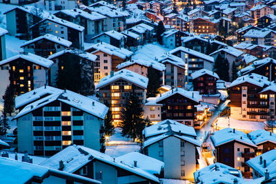 Snow covered houses in town during winter