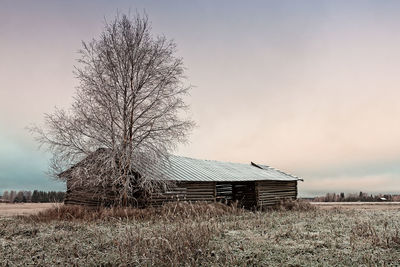 Barn on field against sky