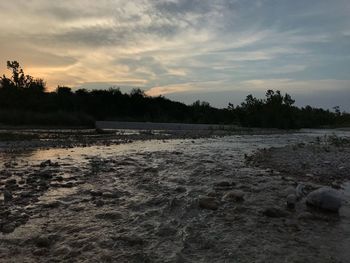 Scenic view of river against sky during sunset