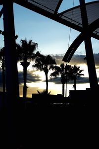 Low angle view of silhouette built structure against sky at sunset