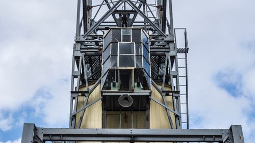 Low angle view of a crane against sky