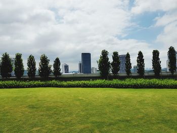 Lawn in park against sky