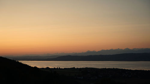 Scenic view of silhouette mountains against sky during sunset