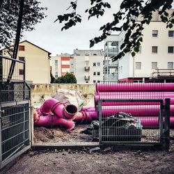 Pink metallic pipes at construction site in city