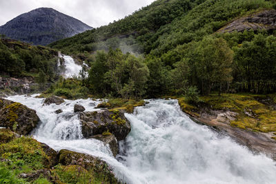 Scenic view of stream flowing through rocks