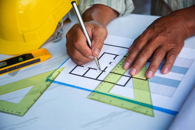 Midsection of man working on table