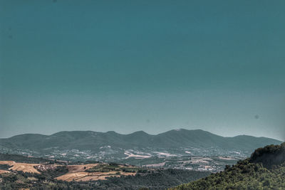 Scenic view of mountains against clear blue sky