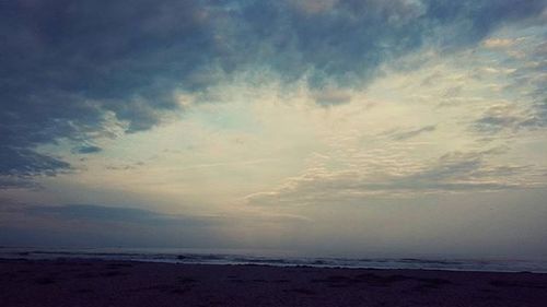 Scenic view of sea against cloudy sky