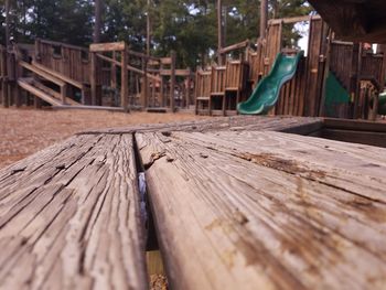 Surface level view of old wooden seat in playground