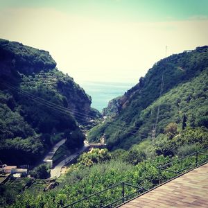 Scenic view of sea and mountains against sky