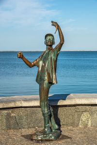 Full length of man standing at beach against sky