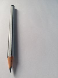 High angle view of colored pencils against white background