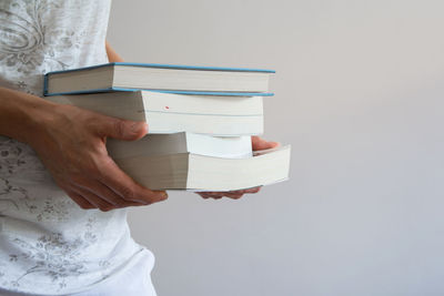 Midsection of woman holding books