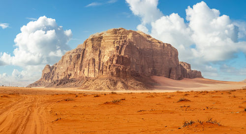 Red sands and huge rock in the middle, wadi rum desert, jordan