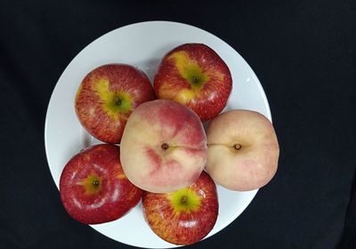 High angle view of apples on table against black background