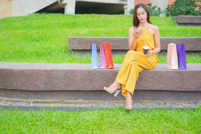 Portrait of happy woman sitting on grass