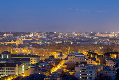 High angle view of illuminated cityscape against sky at night