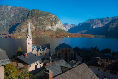 Town by buildings and mountains against sky