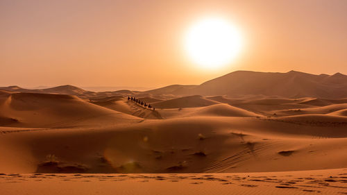 Scenic view of desert against sky during sunset