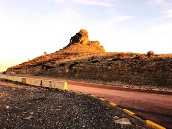 Road passing through landscape against clear sky